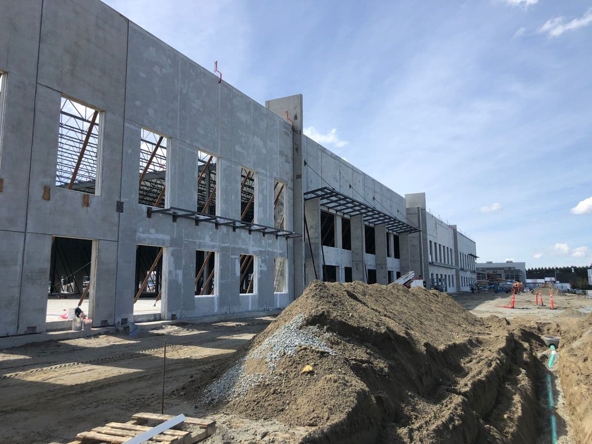 Tilt-up concrete panels erected with window openings framed on a commercial building under construction