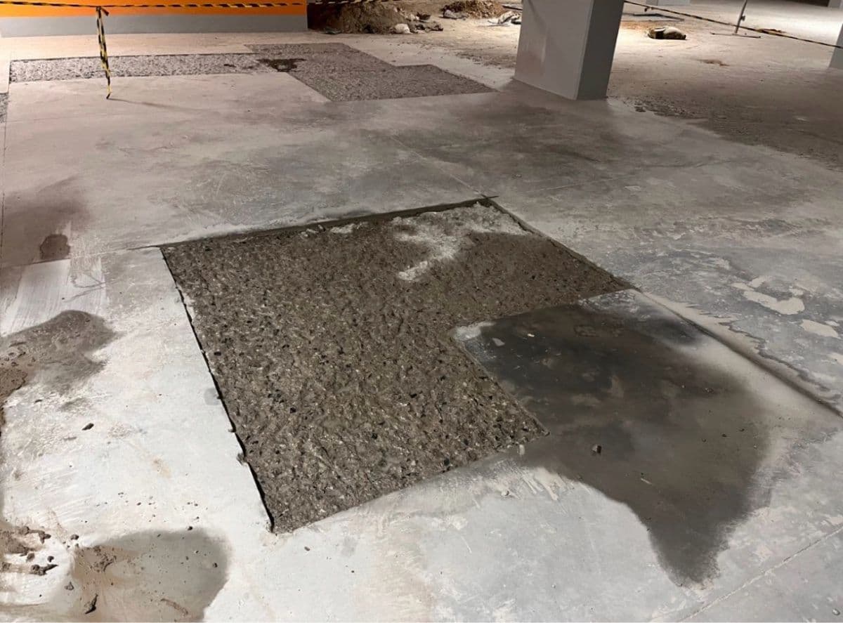 Interior concrete floor slab repair with a freshly patched section by MZ Solution